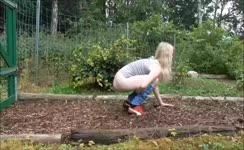 Blonde girl caught shitting in the garden